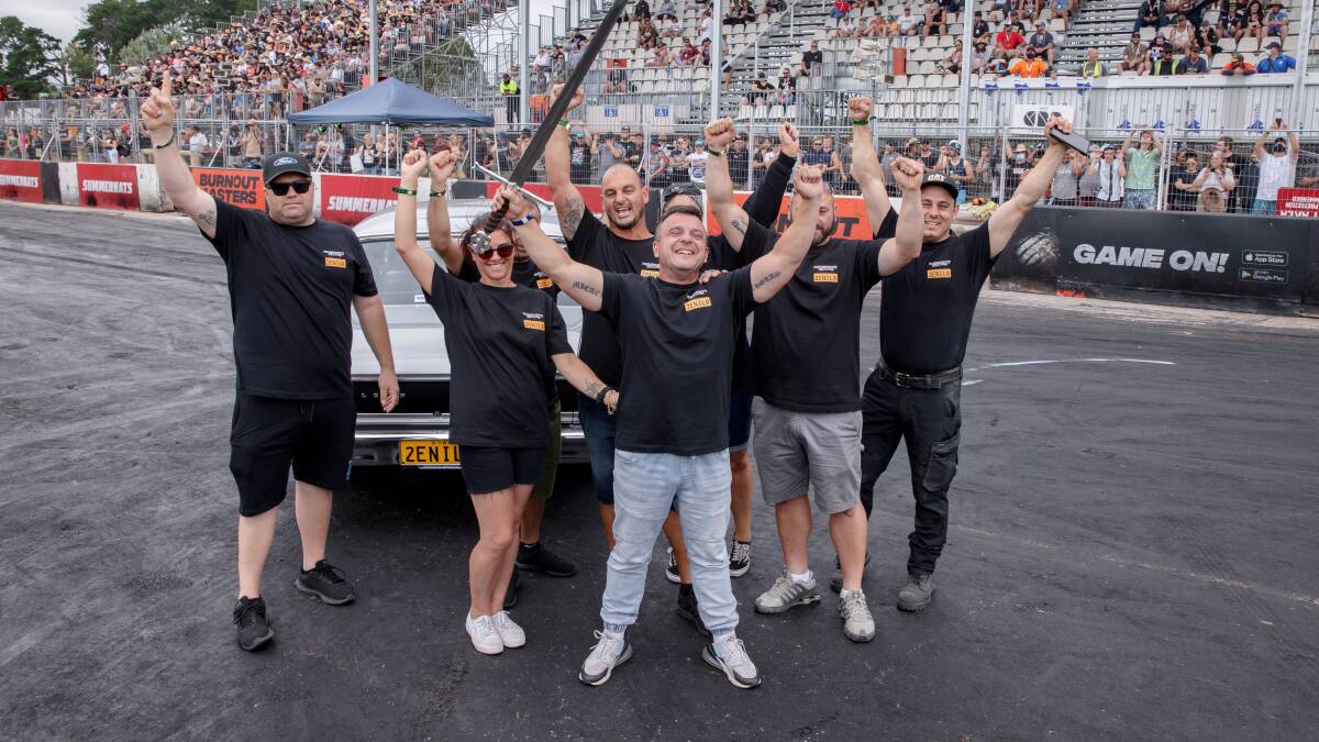 Jason Mansweto celebrates with his team after being crowned the Summernats' grand champion with his Ford Falcon GT. Picture: Sitthixay Ditthavong