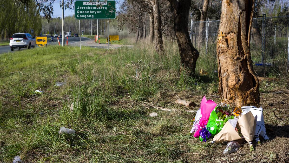 Flowers left at the scene of the crash that claimed the lives of two teenage girls on Sunday. Picture by Sitthixay Ditthavong