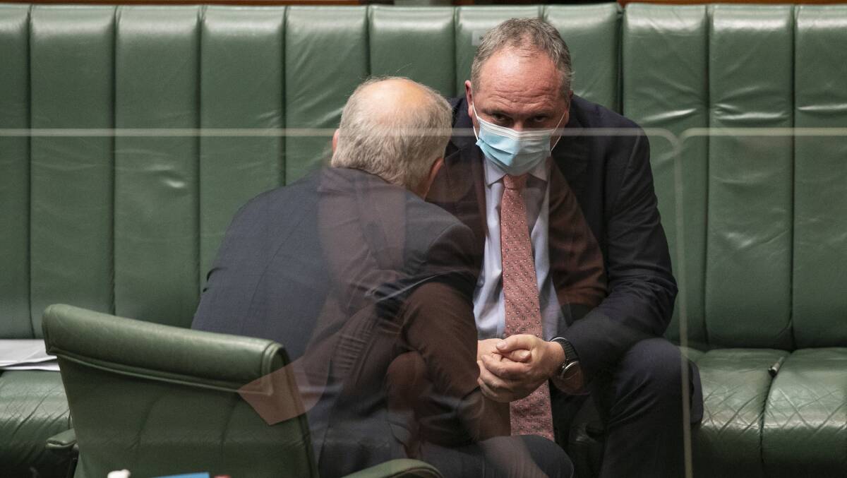Deputy Prime Minister Barnaby Joyce (right) talks to Prime Minister Scott Morrison during question time on Tuesday. Picture: Keegan Caroll