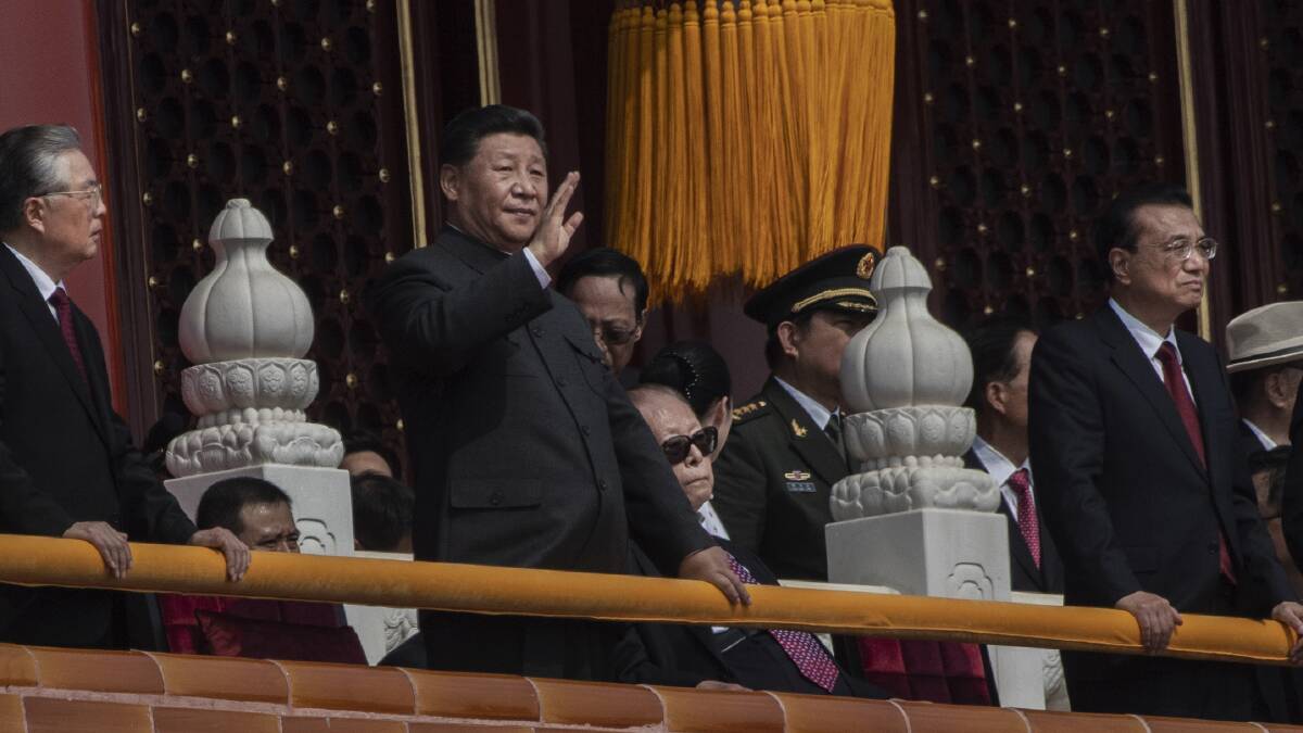 Chinese President Xi Jinping waves from above Tiananmen Gate during a parade to celebrate the 70th anniversary of the founding of the People's Republic of China on October 1. Picture: Getty Images