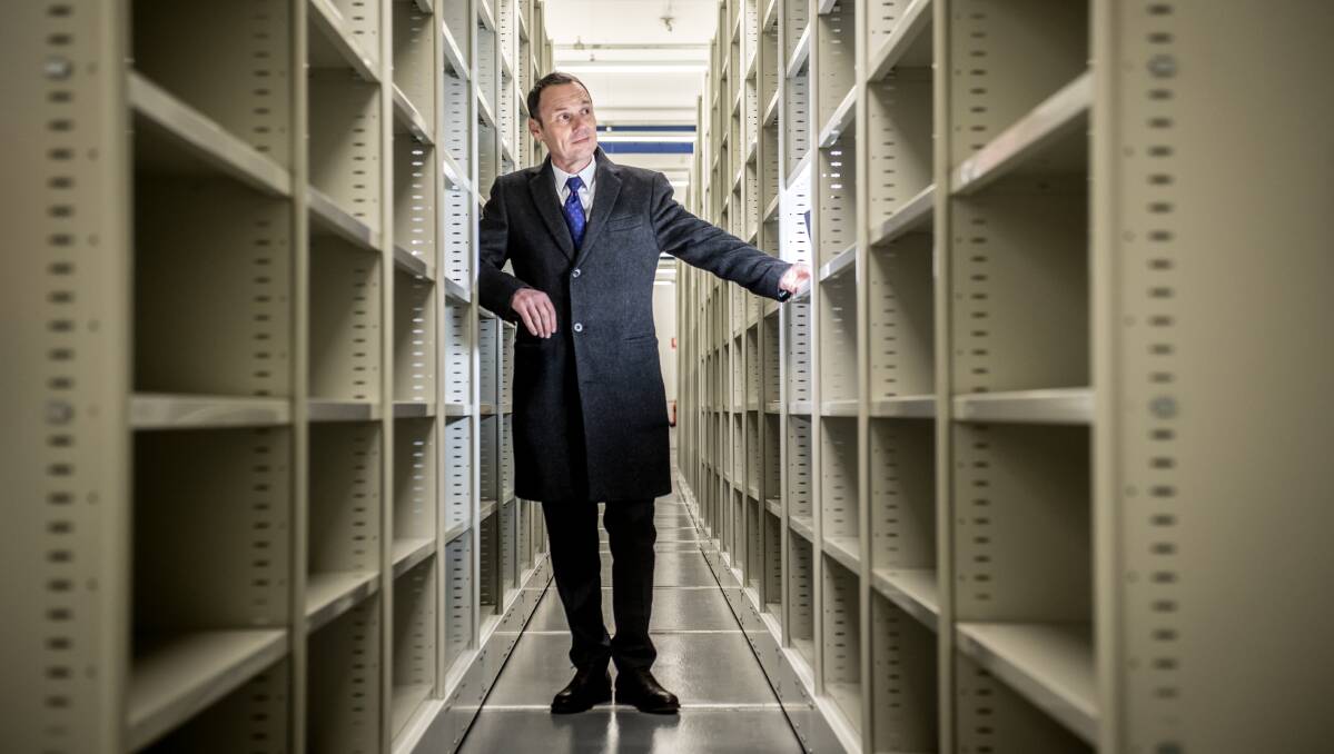 Naitional Archives director-general David Fricker with some of the 75 kilometres of shelving in the Mitchell facility. Picture: Shutterstock