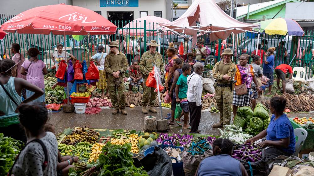 Australian soldiers at the Honiara Central Market. Lockdown is unlikely to be a good fit with Solomon Islands cultural norms. Picture: Department of Defence 