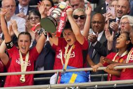 Manchester United's Lucia Garcia lifts the Women's FA Cup at Wembley after they beat Spurs 4-0. (AP PHOTO)
