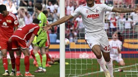 Cologne's Damion Downs wheels away after scoring their crucial late winner against Union. (AP PHOTO)