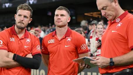 Luke Parker (left) has been praised for his patience by Sydney Swans coach John Longmire (right). (Joel Carrett/AAP PHOTOS)