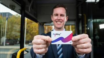 Transport Minister Chris Steel with a new MyWay+ card aboard an electric bus on Thursday. Picture by Elesa Kurtz
