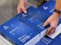 The budget papers are still printed in "budget books" but also issued on a USB and online. (Mick Tsikas/AAP PHOTOS)